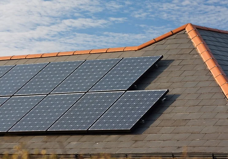 Solar-panels-on-a-slate-roof-under-a-blue-sky